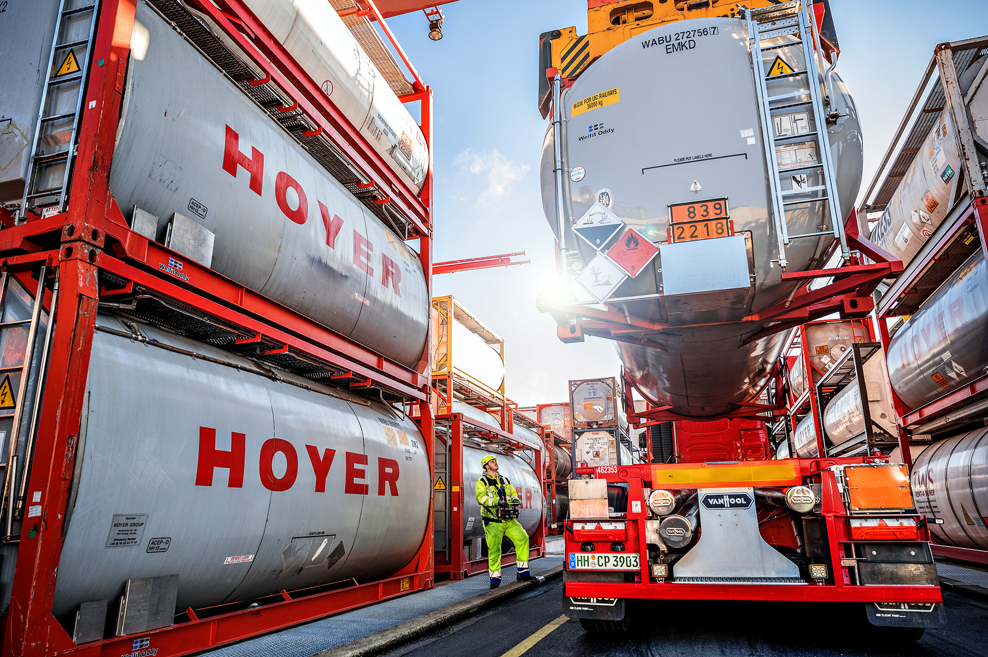 HOYER tank container lifted by a crane at the hazardous goods terminal.