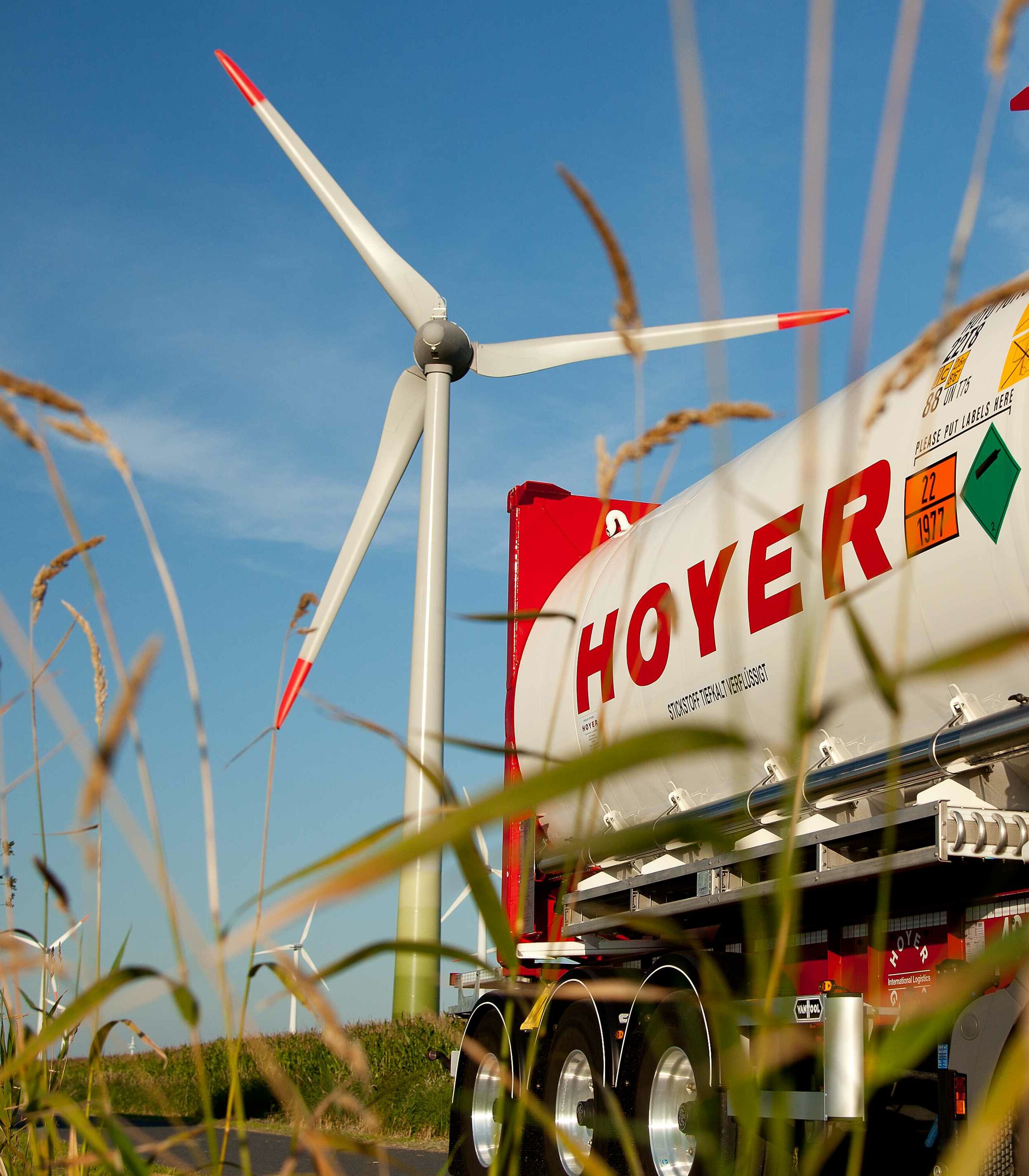 White HOYER nitrogen tank container in front of a wind turbine