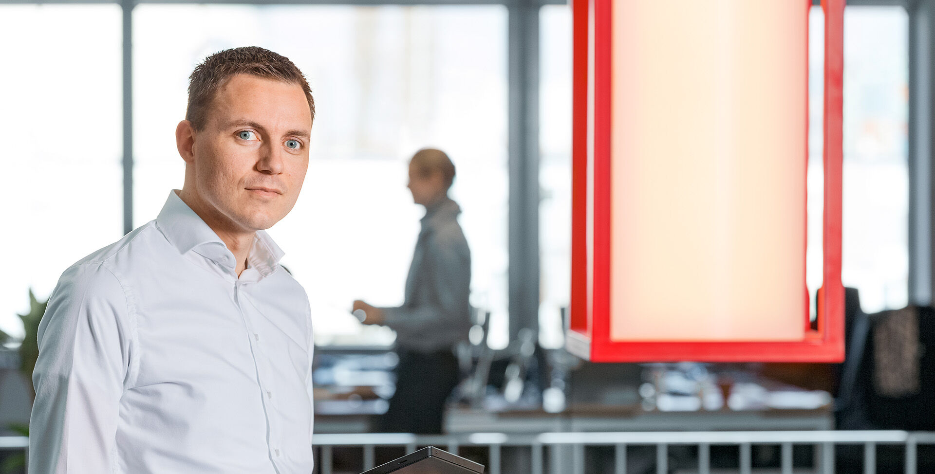 HOYER employee holding a tablet in Rotterdam office