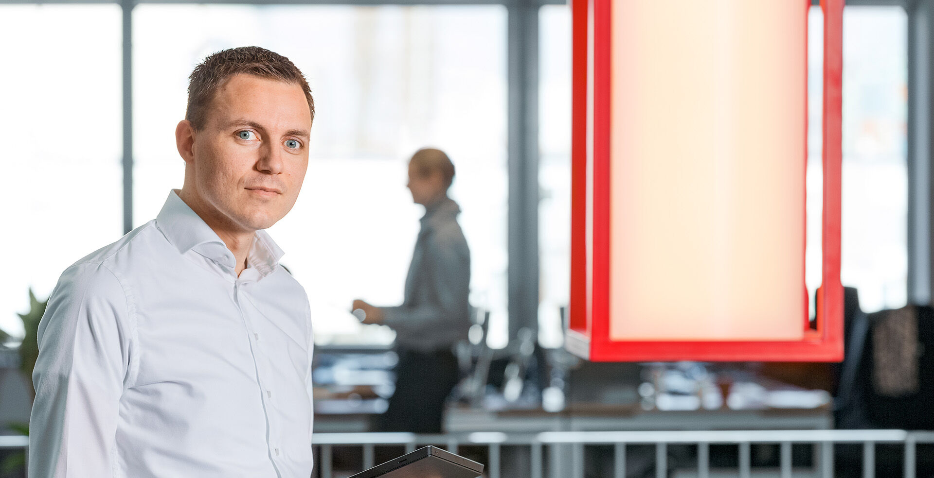 HOYER employee holding a tablet in Rotterdam office