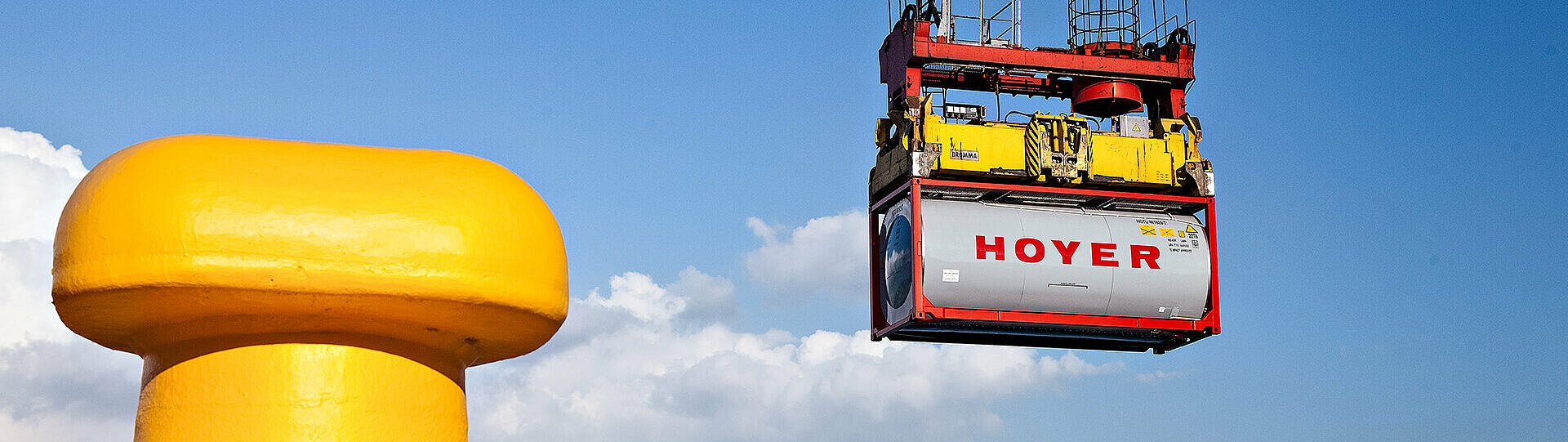 Chemical tank container HOYER grey tank container for chemicals on a crane