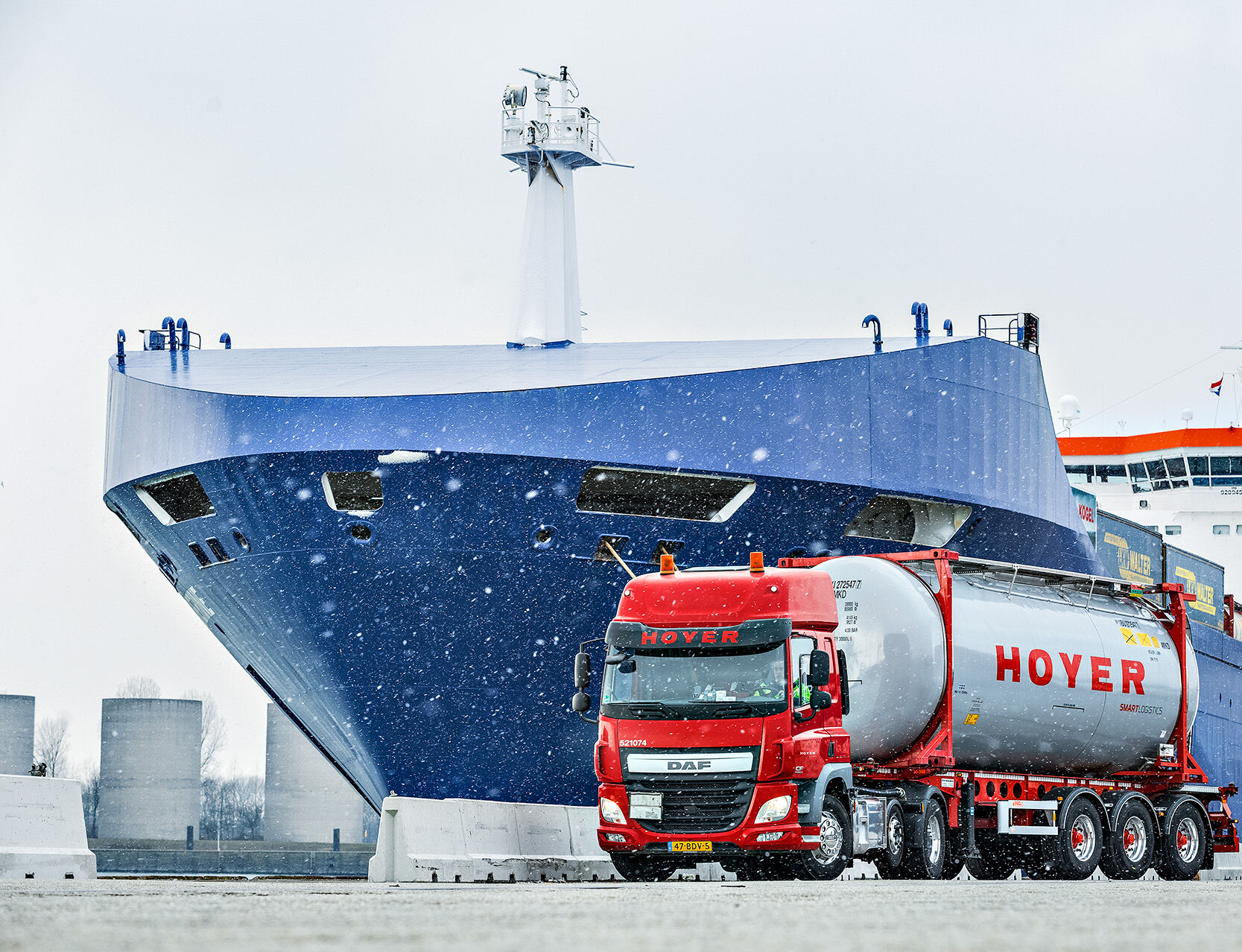 HOYER truck with chemical tank container in front of a ship