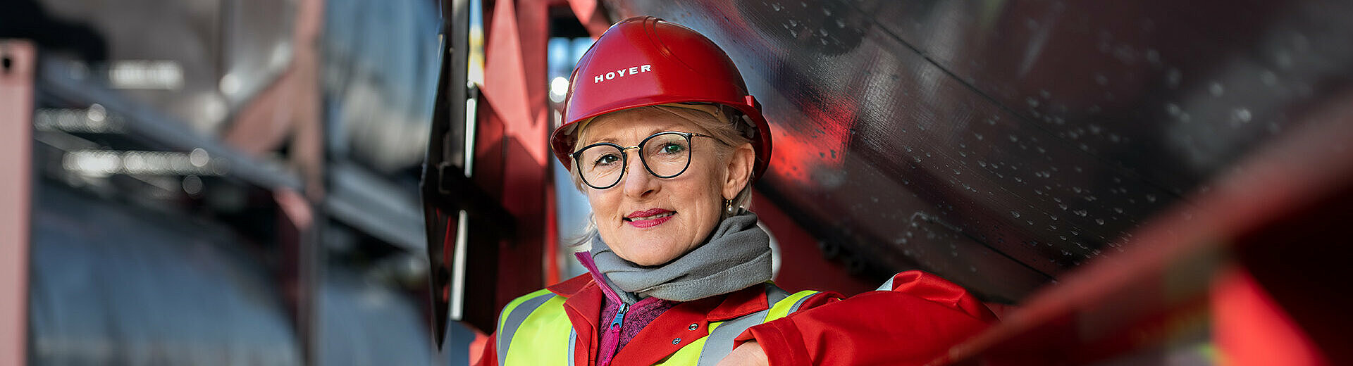 HOYER driver in a safety vest next to a tankcontainer