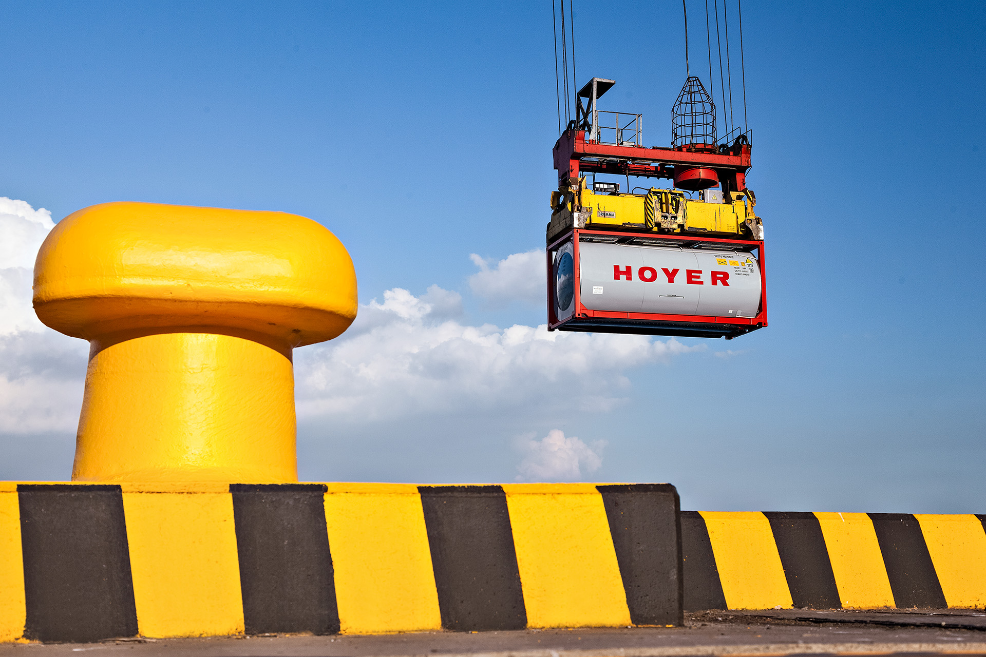 HOYER grey tank container for chemicals on a crane