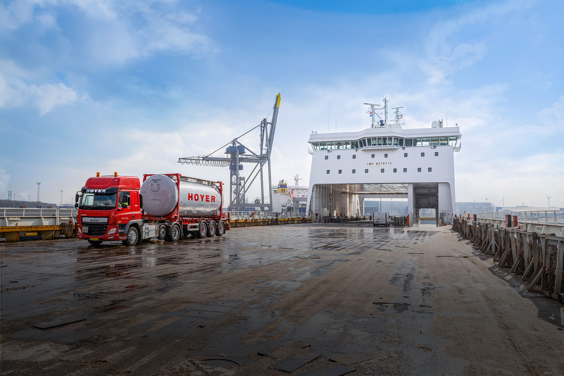 HOYER truck at the port with grey chemical tank container smart logistics