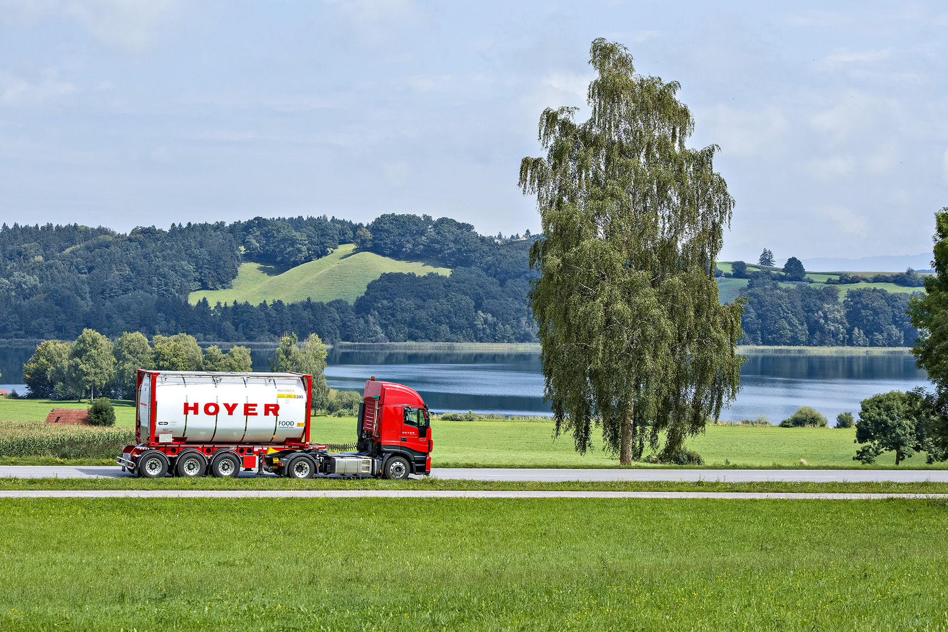 HOYER truck with a foodstuffs tank container on a country road