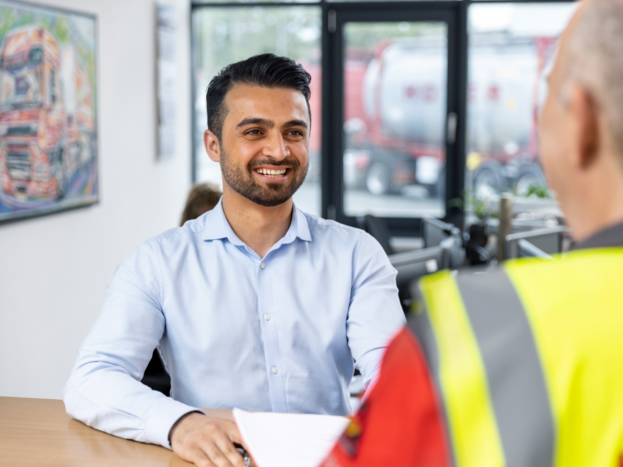 HOYER employee standing infront of a desk 