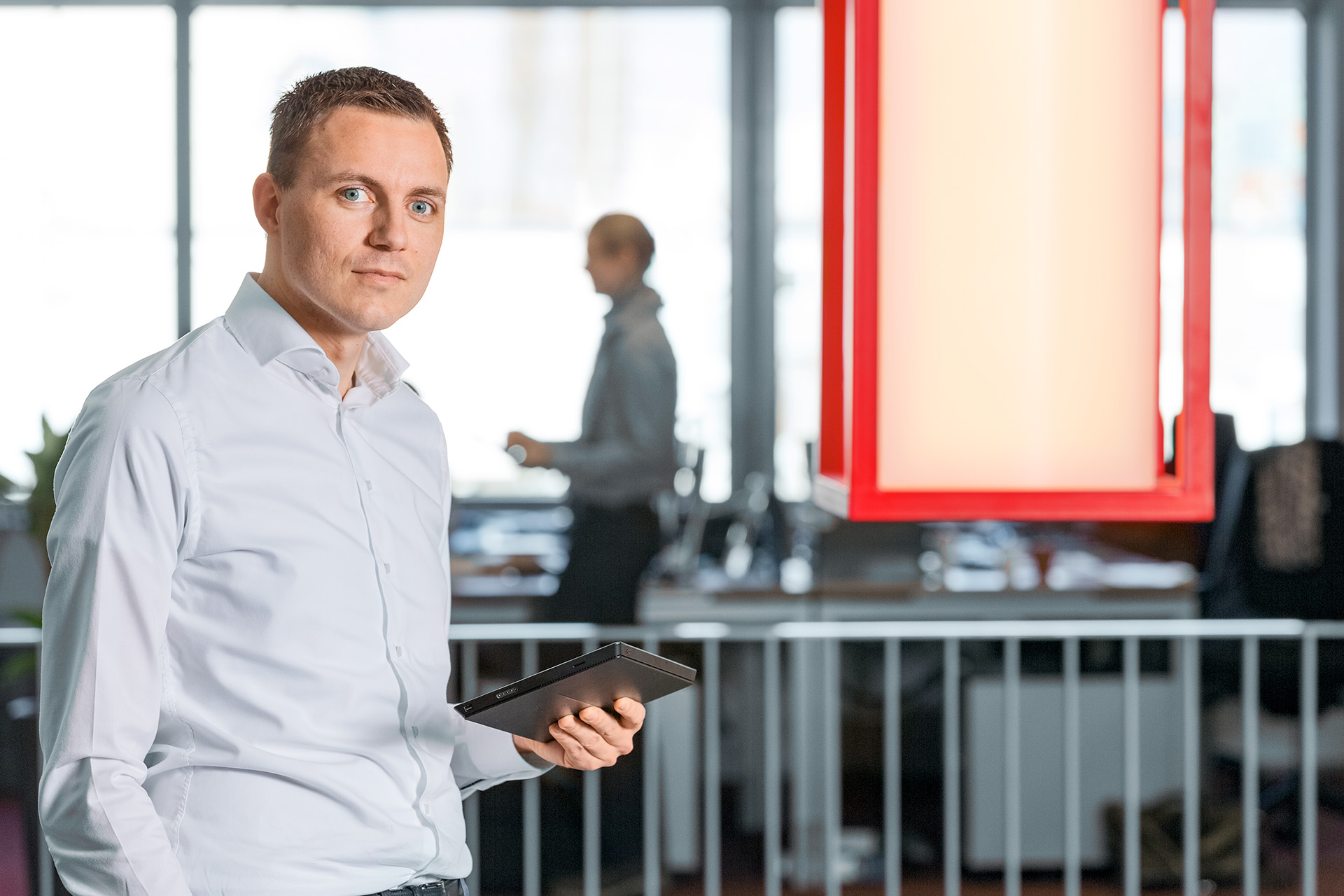 HOYER employee holding a tablet in Rotterdam office